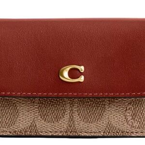 From COACH, the Mini Signature Canvas Trifold Wallet